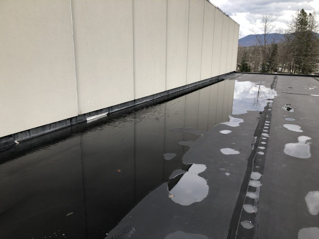 This picture illiterates ponding water on a commercial flat roof.